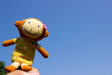 Monkey doll with blue sky background