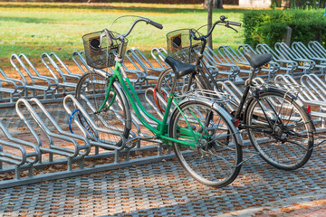 Two bicycles parked in a bicycle parking lot.