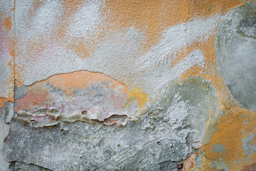 background texture old brick wall with remnants of multi-colored plasters