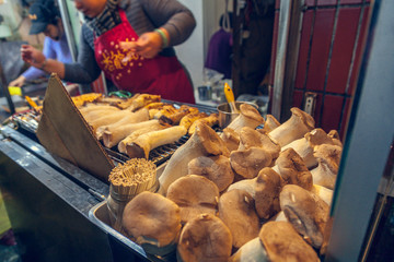 28,Dec, 2014- Jiufen, Taiwan,a women barbecue mushroom in jiufen