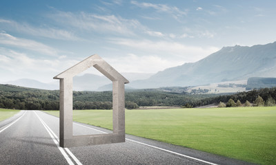 Conceptual background image of concrete home sign on asphalt road