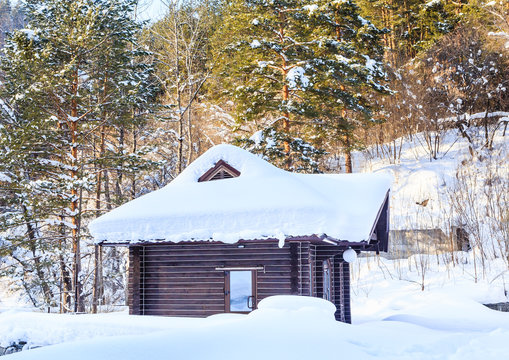 Wooden hut in the snow. Belokurikha, Altai, Russia