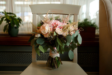 Wedding bouquet of fresh flowers, pink roses and other flowers in composition for bride