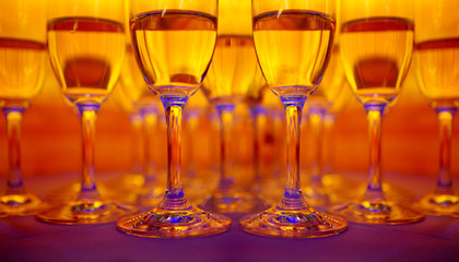 The order of wine glasses on an amber background