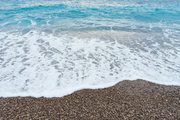 Soft gentle waves with foam in blue ocean italy coast, summer vacation as background