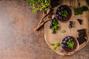 Chocolate pudding with berries and herbs