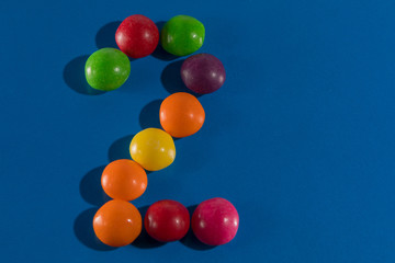 Image of colorful and tasty candies skittles figue postcard