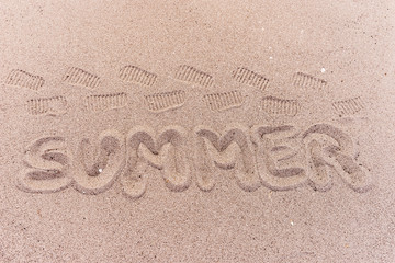 Word summer written on the tropical beach