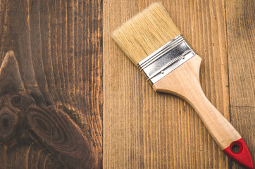 paint brush lying on a wooden background/brush on a wooden background top view