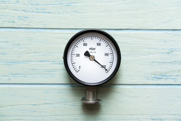 pressure gauge on wood background