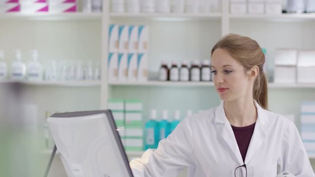  Portrait of friendly smiling worker in a chemist shop
