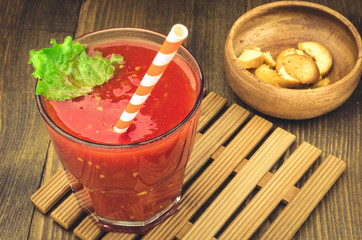 tomato juice with croutons on a wooden background/tomato juice with croutons on a wooden surface