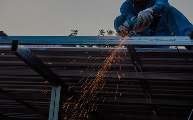 cuts metal by the male worker with many sparks in industrial  steel.