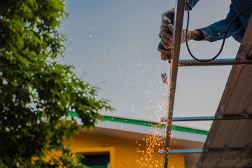cuts metal by the male worker with many sparks in industrial  steel.