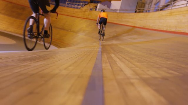  Competitive cyclists racing on track in velodrome