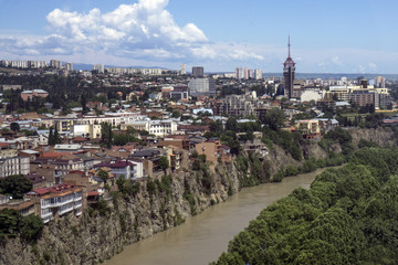 Houses standing on a cliff in the center of Tbilisi