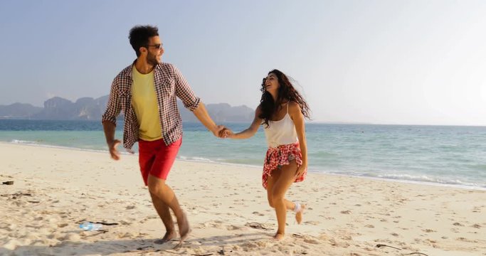 Man Leading Woman From Water, Couple Holding Hands Run On Beach, Happy Smiling Tourists Embrace Slow Motion 60