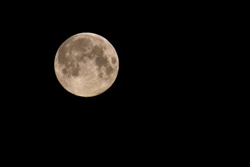 Full moon over dark black sky at night