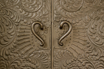 Wrought iron, metal, old, ancient door in a fortress, the castle with metal handles and patterns