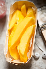 Slices of mango and multivitamin drink - healthy breakfast
