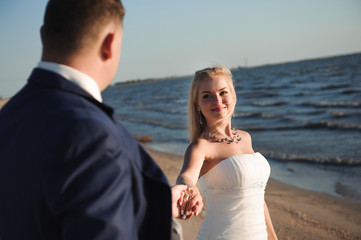 Bride and groom by the sea on their wedding day