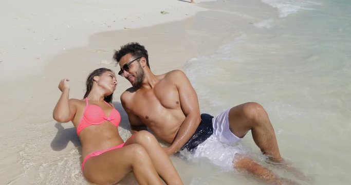 Happy Сouple Lying In Water On Beautiful Beach, Man And Woman In Love Tourists On Summer Holiday Slow Motion 60