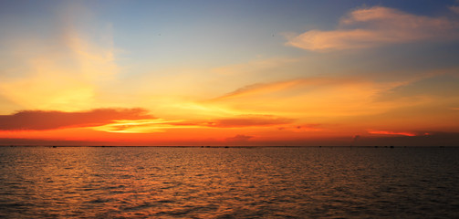 Obraz na płótnie Canvas Panorama view of sunset over shell farm