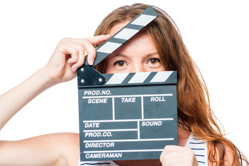 Close-up of an actress looking after a movie clapper on a white background