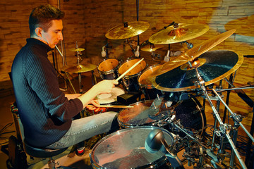 Fototapeta na wymiar Drummer playing on drum set on stage, Toned image