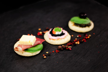 Homemade pancake canapes on slate stone plate for finger food party