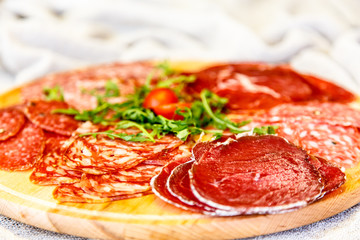 Cut into thin slices of different Italian sausages.