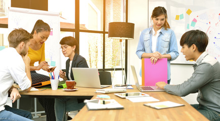 Fototapeta premium Group of businesspersons having different age in creative business discussing work in the office