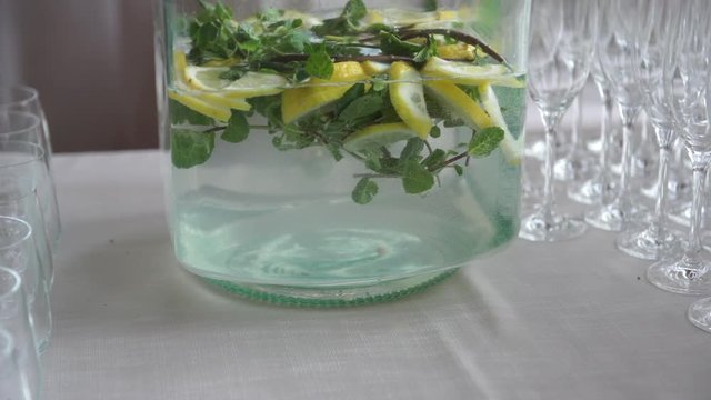 Water with lemon and mint and empty flutes on the wedding catering in Italy, 4K