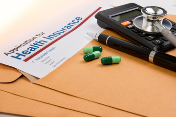 Application form for health insurance, paperwork, questionnaire, pen, tablet, calculator, envelope and stethoscope. Calculate for health insurance concept.