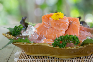 Sashimi sanmal, japanese food  in the dish on the old table in green garden / Selective focus ..