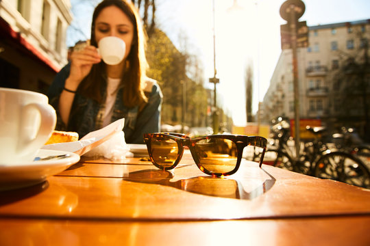 A girl sitting with coffee in a cafe of Berlin