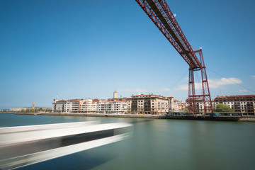 Fototapeta premium Daylight long exposure of Vizcaya hanging bridge and Nervion river in Portugalete, Bilbao, Spain.