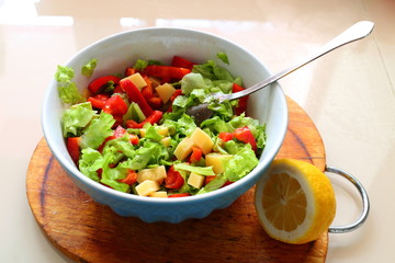 Salad sweet red pepper, leafs green salad and cheese with sauce of lemon and olive oil