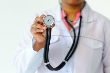 Stethoscope in focus in hand of doctor