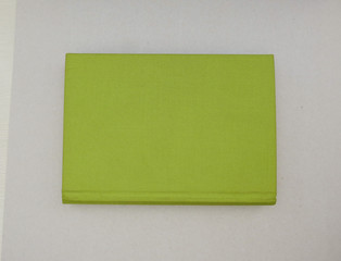 book with green fabric cover