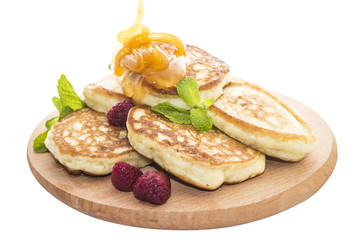Cheese pancakes with raspberries and honey