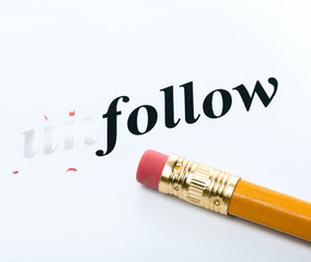 Word " unfollow " and pencil with eraser close-up