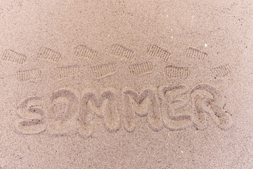 Word summer (Sommer) in german written on the beach