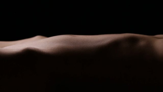 Slim beautiful body of unrecognizable female. Vertical panning. Seamless loop