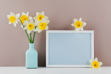 Mockup of picture frame decorated narcissus flowers in vase with empty space for text your blogging and greeting for mother day.