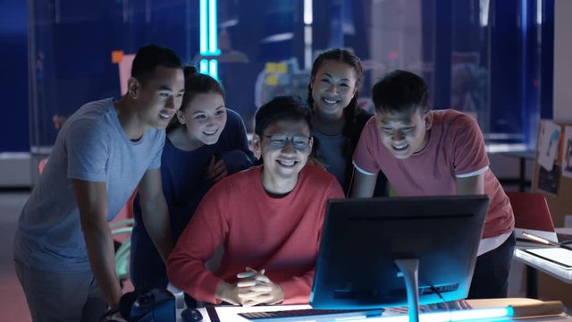  Portrait smiling Asian game developers in creative office