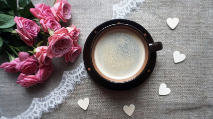 Obraz na płótnie Canvas Vintage cup of coffee and a flowers