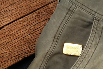 Gold bar put in the pant pocket also represent business concept.
