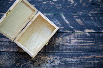 Open empty wood box on wooden background