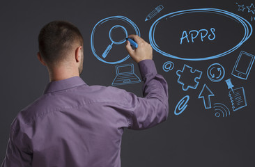 Business, Technology, Internet and network concept. A young businessman writes on the blackboard the word: APPS